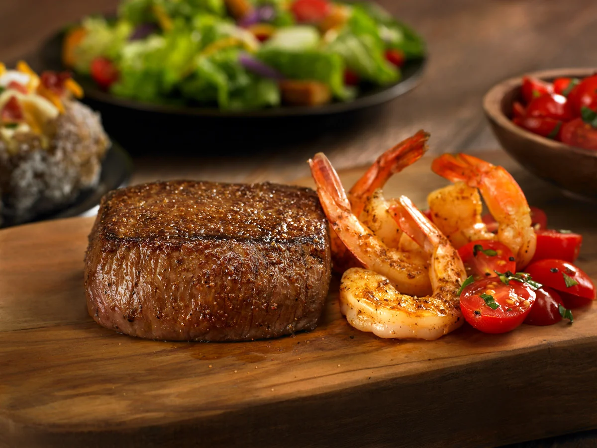 Victoria's filet with shrimp and tomatoes on the side
