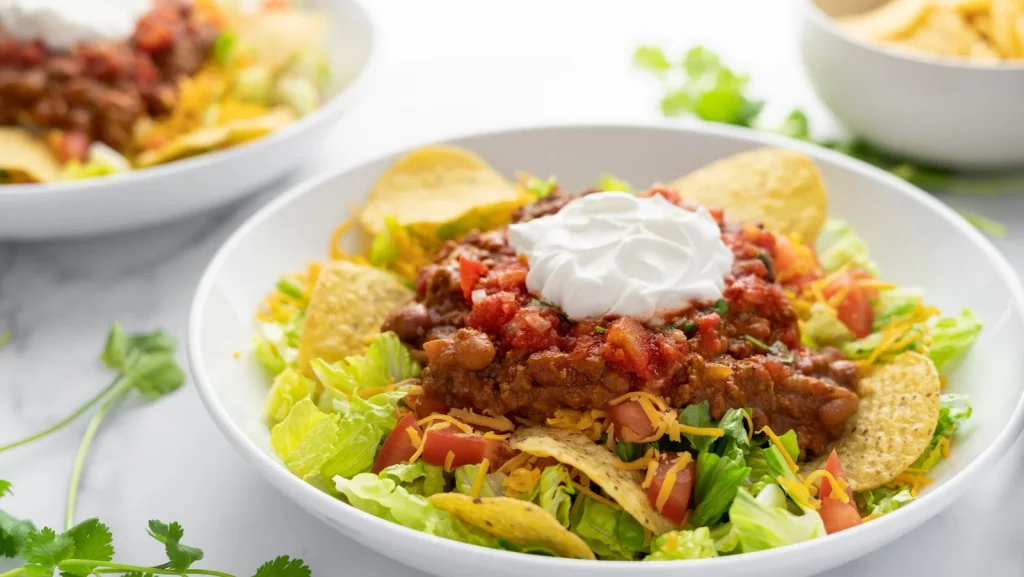 Taco salad with salas and sour cream on the top. 