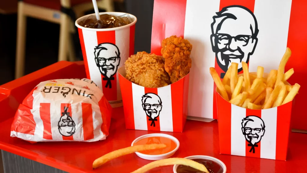 Crispy chicken wings, fries, burger, and a beverage at KFC