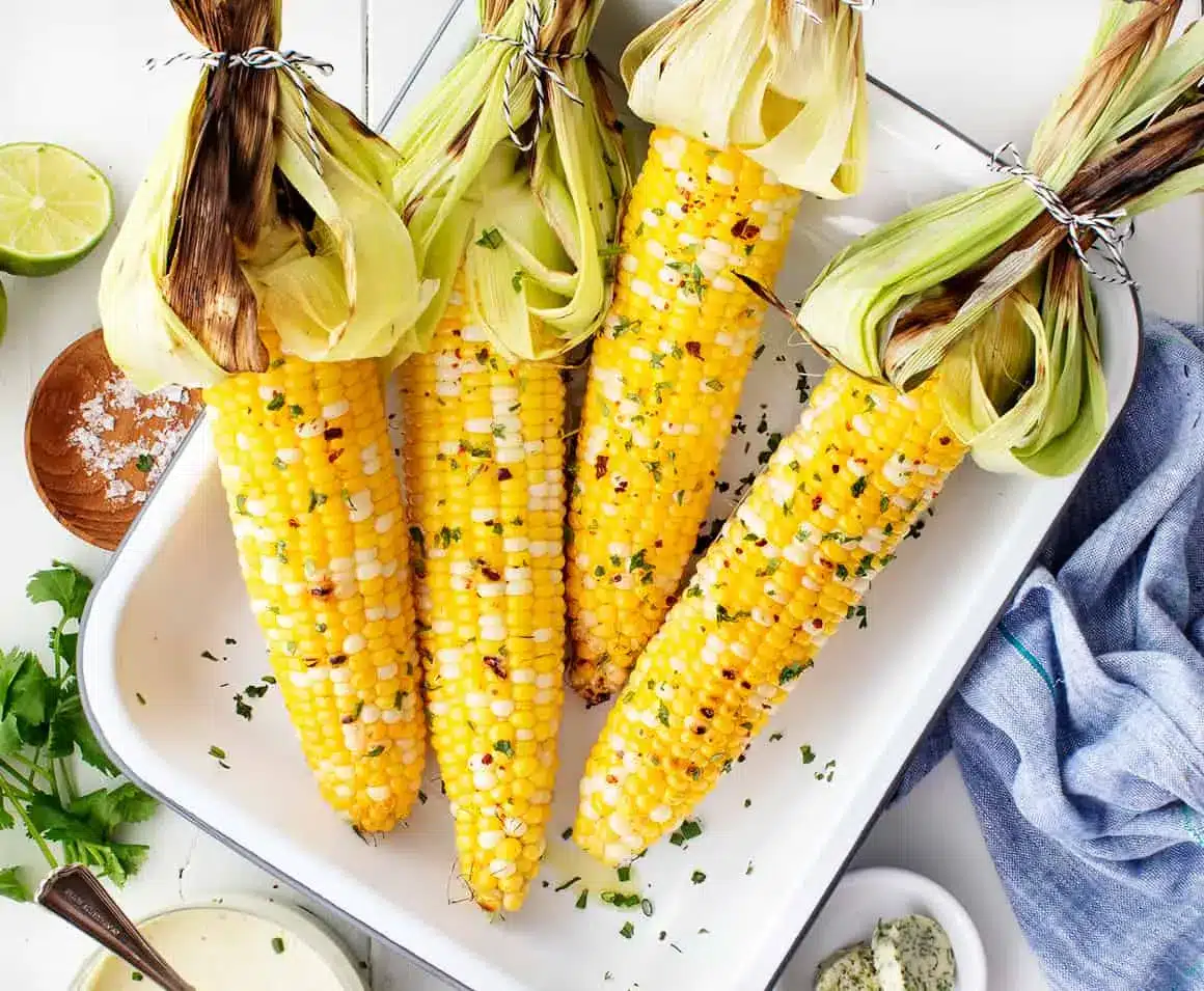 Grilled Corn On The Cob Served In White Plate