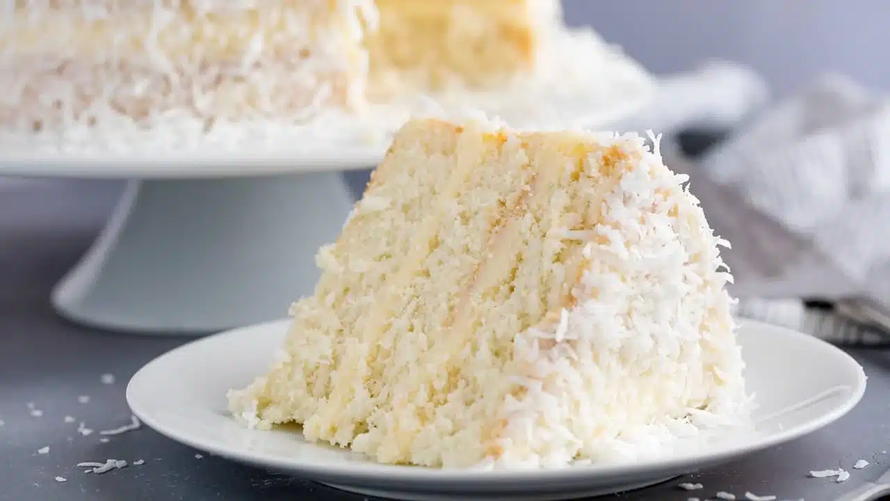 A Piece Of Coconut Cake Served On Plate