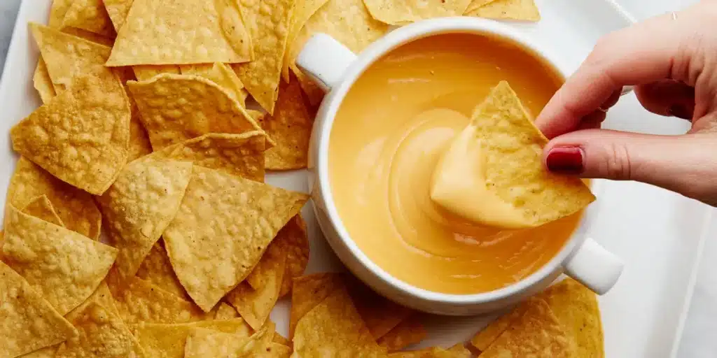 Dipping Nachos in Chipotle Queso