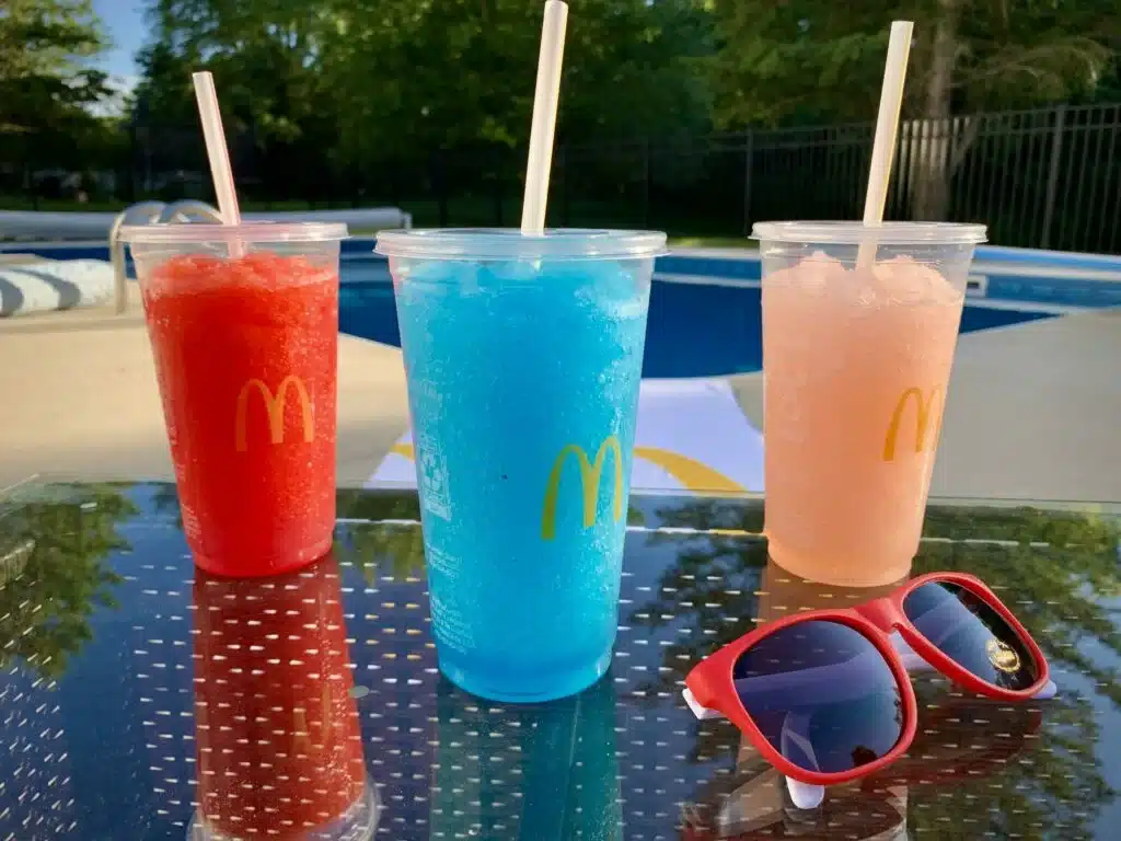 Three slushies placed on table in different colors